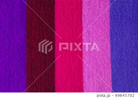 multi colored background. knitted wool fabric texture with stripes 99645702