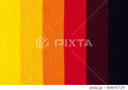 multi colored background. knitted wool fabric texture with stripes 99645724