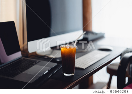 iced coffee on desk at home iced coffee on desk at home 99646293