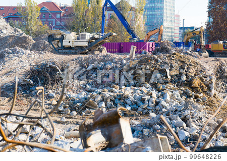 Background of process of demolition of building. Excavator breaking old house. 99648226