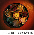 a round box of chocolates in which some of the sweets were replaced with Christmas decorations 99648410