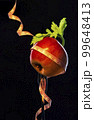 apple and celery leaf wrapped with tailor's ribbon on a fork 99648413