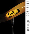 a metaphorical composition about a fork in the road, the fork holds the road along which the car is driving, consecrating the road with headlights 99648414