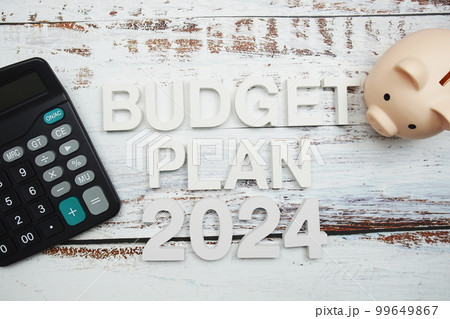 Budget Plan 2024 alphabet letter with calculator and piggy bank on wooden background Budget Plan 2024 alphabet letter with calculator and piggy bank on wooden background 99649867