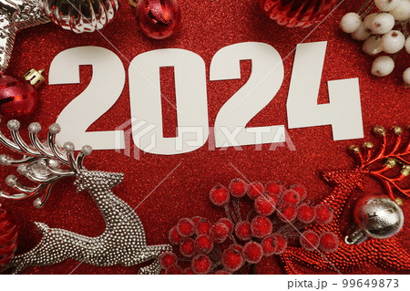 2024 Happy New Year and Christmas decoration on red glitter background 99649873