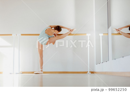 Beautiful teen girl, ballet dancer, standing near barre. Model training at dance school with on daytime with sunlight. Concept of classical ballet, art, choreography Beautiful teen girl, ballet dancer, standing near barre. Model training at dance school with on daytime with sunlight. Concept of classical ballet, art, choreography 99652250