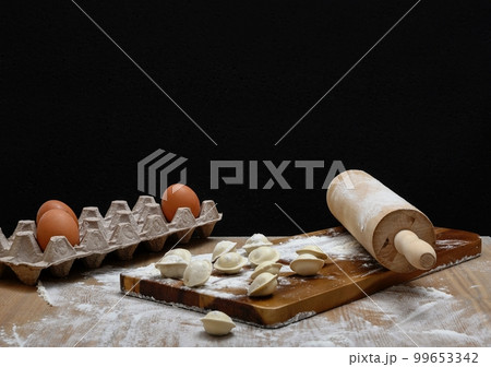 The cozy kitchen of a farmhouse and the process of preparing traditional food - dumplings. 99653342