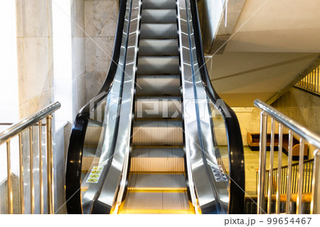 moving escalator with yellow electric backlight moving escalator with yellow electric backlight 99654467