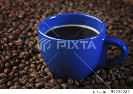 A Cup of fresh coffee. Roasted coffee beans background. Organic coffee. A Cup of fresh coffee. Roasted coffee beans background. Organic coffee. 99656027