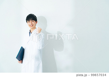 ガッツポーズする白衣を着た若い男性 理系男子 医大生 ガッツポーズする白衣を着た若い男性 理系男子 医大生 99657034