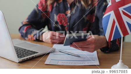 British embassy woman officer giving passport to man immigrant, student visa approval, work visa, citizenship. Visa Application online form immigration concept. Visa approval. 99657085