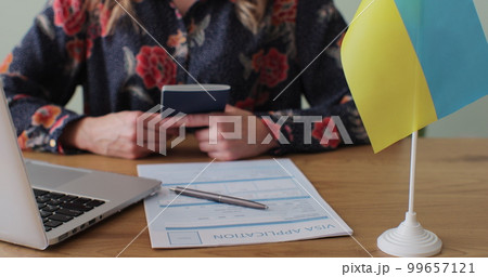 Ukranian embassy woman officer giving passport to man immigrant, student visa approval, work visa, citizenship. Visa Application online form immigration concept. Visa approval. Ukranian embassy woman officer giving passport to man immigrant, student visa approval, work visa, citizenship. Visa Application online form immigration concept. Visa approval. 99657121