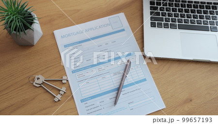 Mortgage Loan Application showing with laptop computer on a desk. Bank loan agreement or real estate rental contract. Write business agreement for entrepreneur. 99657193