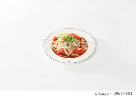 Papaya salad with pickled fish in a white dish. Papaya salad with pickled fish in a white dish. 99657801