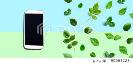 White smartphone with green leaves White smartphone with green leaves 99661128