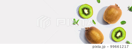 Fresh green kiwis overhead view 99661217