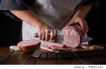 Mortadella. Traditional pork sausage with pistachios or black pepper. Italian delicacy from Bologna. Mortadella. Traditional pork sausage with pistachios or black pepper. Italian delicacy from Bologna. 99663283