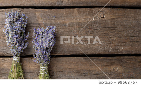 bouquets of dried lavender on a dark wooden background. Autumn background. top view. place for text. banner bouquets of dried lavender on a dark wooden background. Autumn background. top view. place for text. banner 99663767