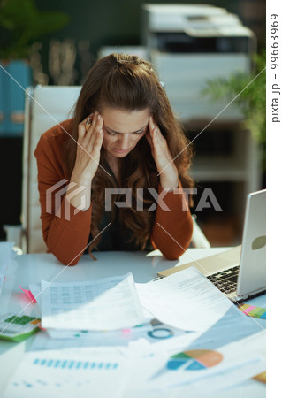 business owner woman in green office working with documents business owner woman in green office working with documents 99663969