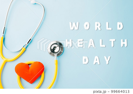 World Health Day. Yellow doctor stethoscope and world globe with Red heart shape isolated on blue background with copy space, Save world day, Healthcare life Insurance, Health care and medical concept World Health Day. Yellow doctor stethoscope and world globe with Red heart shape isolated on blue background with copy space, Save world day, Healthcare life Insurance, Health care and medical concept 99664013