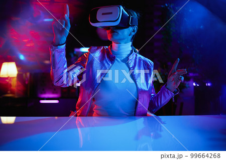modern woman in vr headset in modern office 99664268