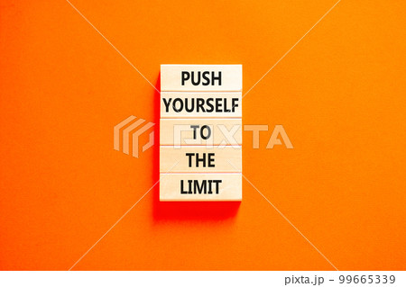 Push the limit symbol. Concept words Push yourself to the limit on wooden blocks. Beautiful orange table orange background. Business push the limit concept. Copy space. Push the limit symbol. Concept words Push yourself to the limit on wooden blocks. Beautiful orange table orange background. Business push the limit concept. Copy space. 99665339