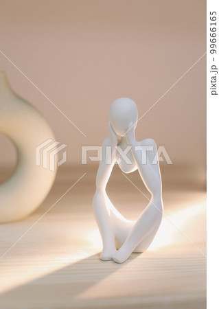 White gypsum decorative figure against beige background with copy space. Concept of template for website or commercial banner White gypsum decorative figure against beige background with copy space. Concept of template for website or commercial banner 99666165