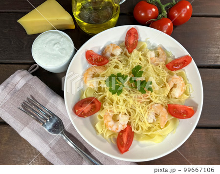 Pasta with shrimps, tomatoes and parmesan cheese Pasta with shrimps, tomatoes and parmesan cheese 99667106