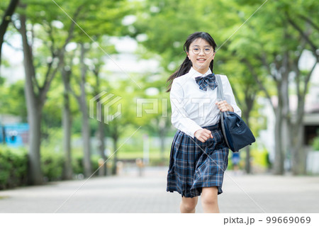 通学する夏服の学生服を着た女子中学生 99669069