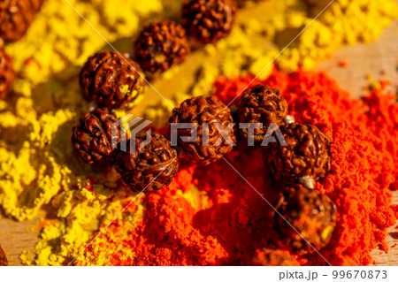 Colorful traditional holi powder on the table with wooden prayers indian beads. Happy holi. Concept Indian color festival called Holi. Organic Gulal dust.  99670873