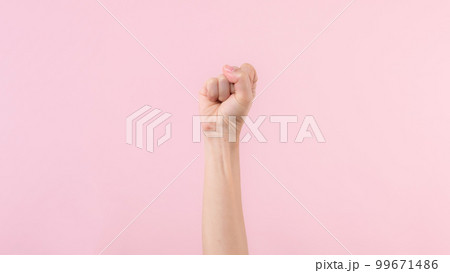 Woman fist fight for human rights and feminist with pink pastel background. Women empowerment, equality, strength and courage concept 99671486