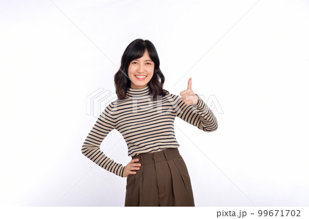 Young confident asian woman with sweater cloths showing thumb up in approval, recommending, standing isolated on white background Young confident asian woman with sweater cloths showing thumb up in approval, recommending, standing isolated on white background 99671702