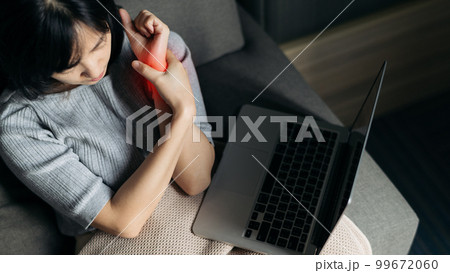 Asian woman has shoulder pain. Female holding painful shoulder with another hand. People with body-muscles problem, Healthcare And Medicine. Asian woman has shoulder pain. Female holding painful shoulder with another hand. People with body-muscles problem, Healthcare And Medicine. 99672060