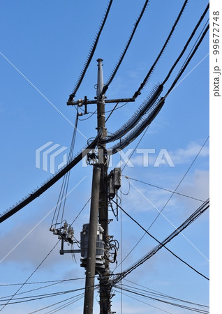 様々なケーブルや電線とそれらを支える電柱 様々なケーブルや電線とそれらを支える電柱 99672748