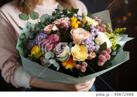 Luxury bouquet beautiful of mixed flowers in woman hand. 99672988
