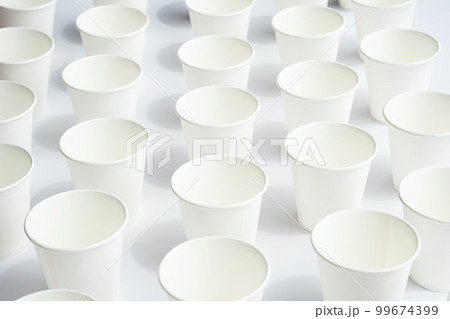 Several disposable white paper cups. Mock up to go coffee cups with shadows on white. 99674399