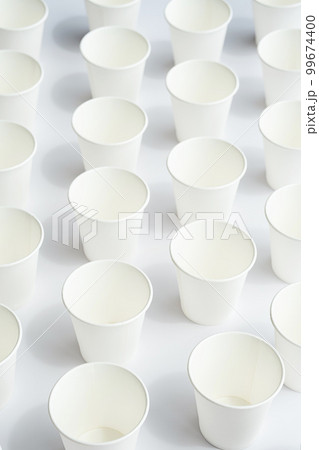 Several disposable white paper cups. Mock up to go coffee cups with shadows on white. Several disposable white paper cups. Mock up to go coffee cups with shadows on white. 99674400