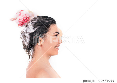 Lady with soapy head takes care of the scalp with massager in pink against white background Lady with soapy head takes care of the scalp with massager in pink against white background 99674955