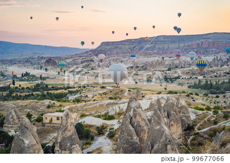Colorful hot air balloon flying over Cappadocia, Turkey 99677066