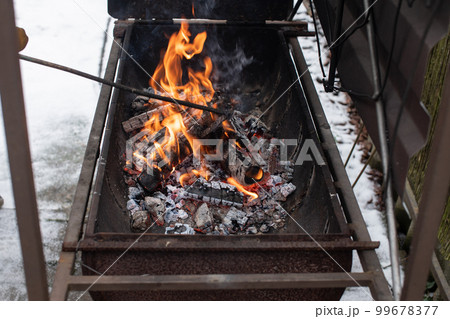 Kindling a fire in the brazier, burning coals Kindling a fire in the brazier, burning coals 99678377
