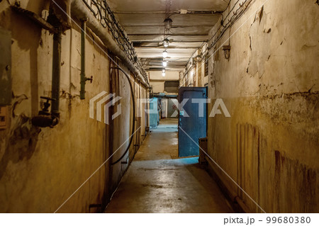 Abstract dark corridor of military bunker interior, grungy old underground tunnel. Nuclear shelter 99680380