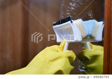 Close up of man hand cleaning window glass Close up of man hand cleaning window glass 99680793