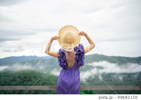 Carefree happy woman in morning of nature cliff mountain. Woman travel tourist alone morning freedom and happiness Carefree happy woman in morning of nature cliff mountain. Woman travel tourist alone morning freedom and happiness 99682150