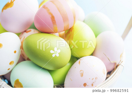 Easter basket filled with painted Easter eggs. Colorful painted Easter eggs 99682591