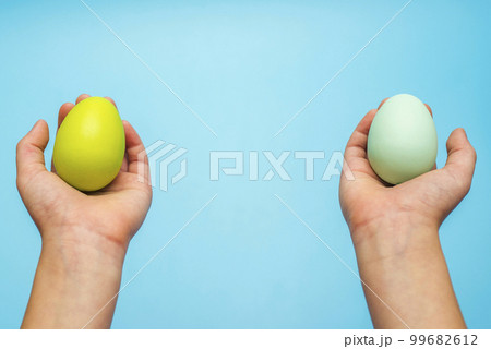 Easter eggs in childs hands on blue background 99682612