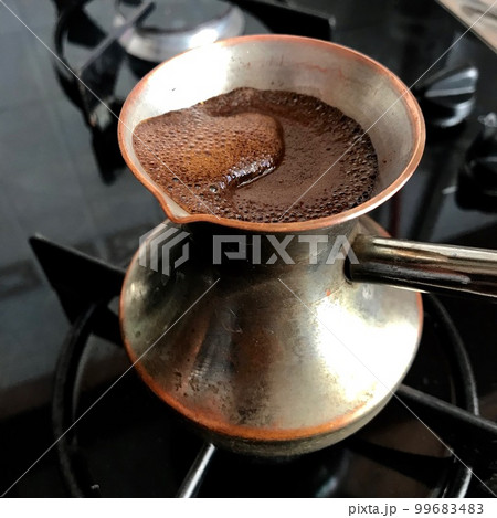 Barista preparing hot tasty drink from copper turk Barista preparing hot tasty drink from copper turk 99683483