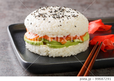 Homemade asian style gluten free sushi salmon burger close-up on a plate. Horizontal 99687291