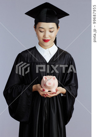 young female asian graduate student isolated on grey background 99687955