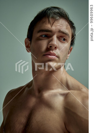 Relief body. Portrait of handsome young man with muscular body posing shirtless over pale green over studio background. Concept of men's health, beauty, sport Relief body. Portrait of handsome young man with muscular body posing shirtless over pale green over studio background. Concept of men's health, beauty, sport 99689963