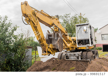 Bucket and hydraulic piston excavator or bulldozer close-up in industrial zone 99691517